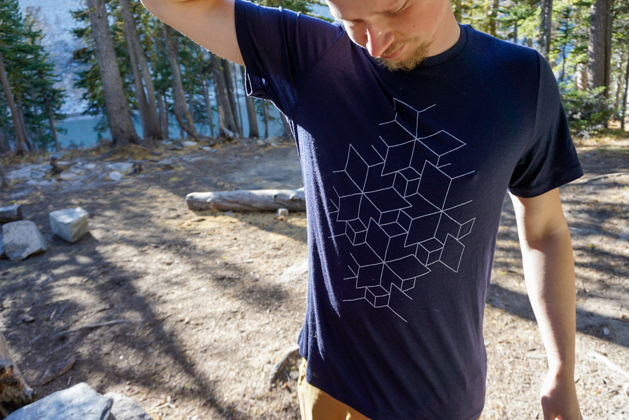 Close-up detail of the fabric and branding on an Icebreaker Tech Lite merino shirt.