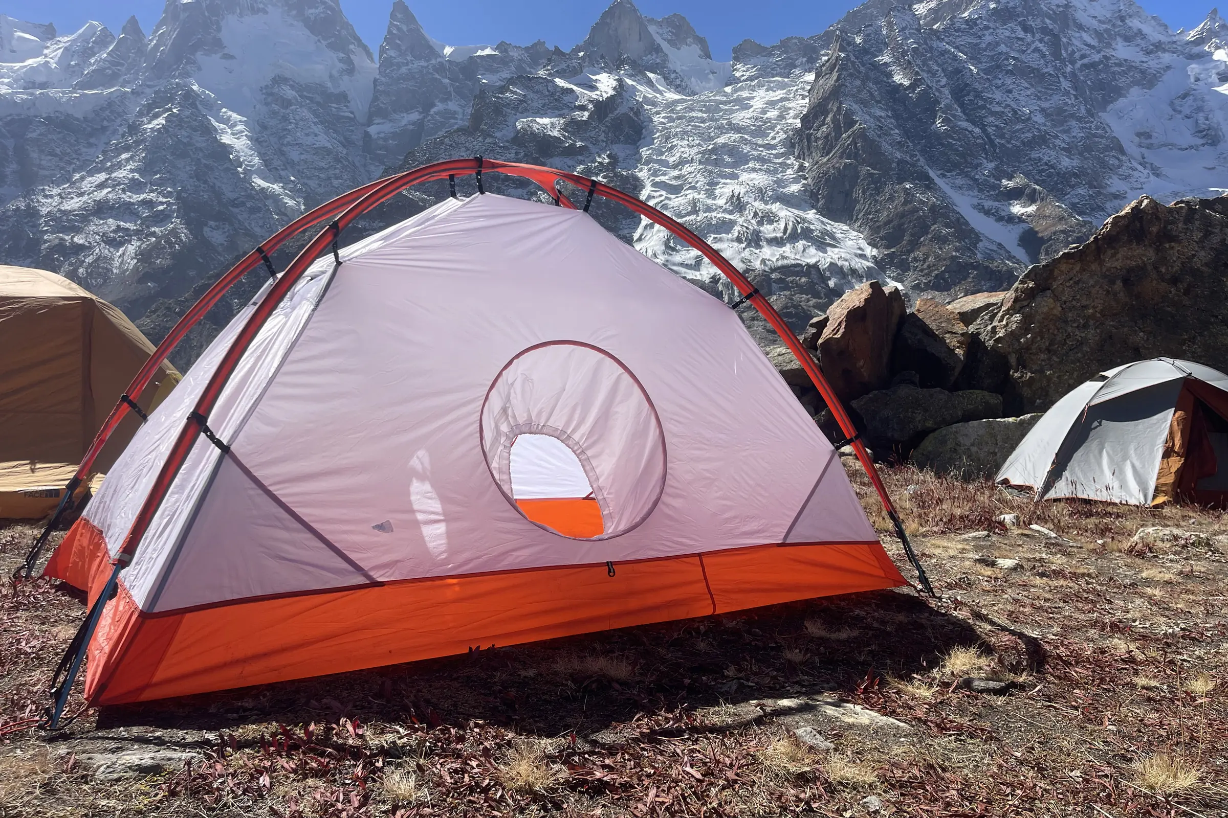 A SlingFin tent pitched on a steep, snow-covered slope in the Indian Himalayas.