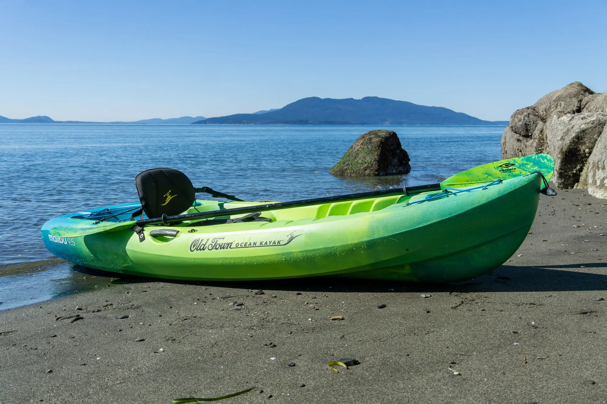 A side-by-side comparison of a sit-on-top kayak and a sit-inside kayak.