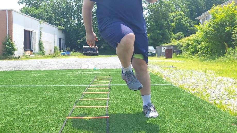Man performing athletic drills in Fabletics shorts