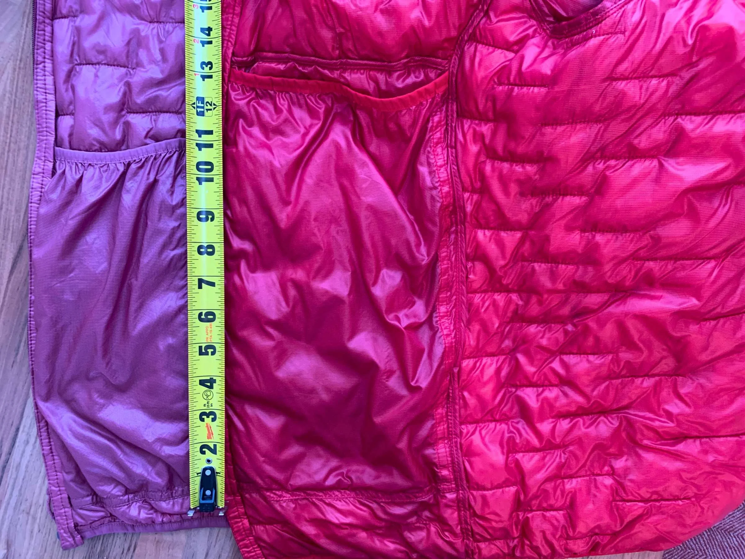 Detailed view of large internal drop-in pockets in a synthetic jacket