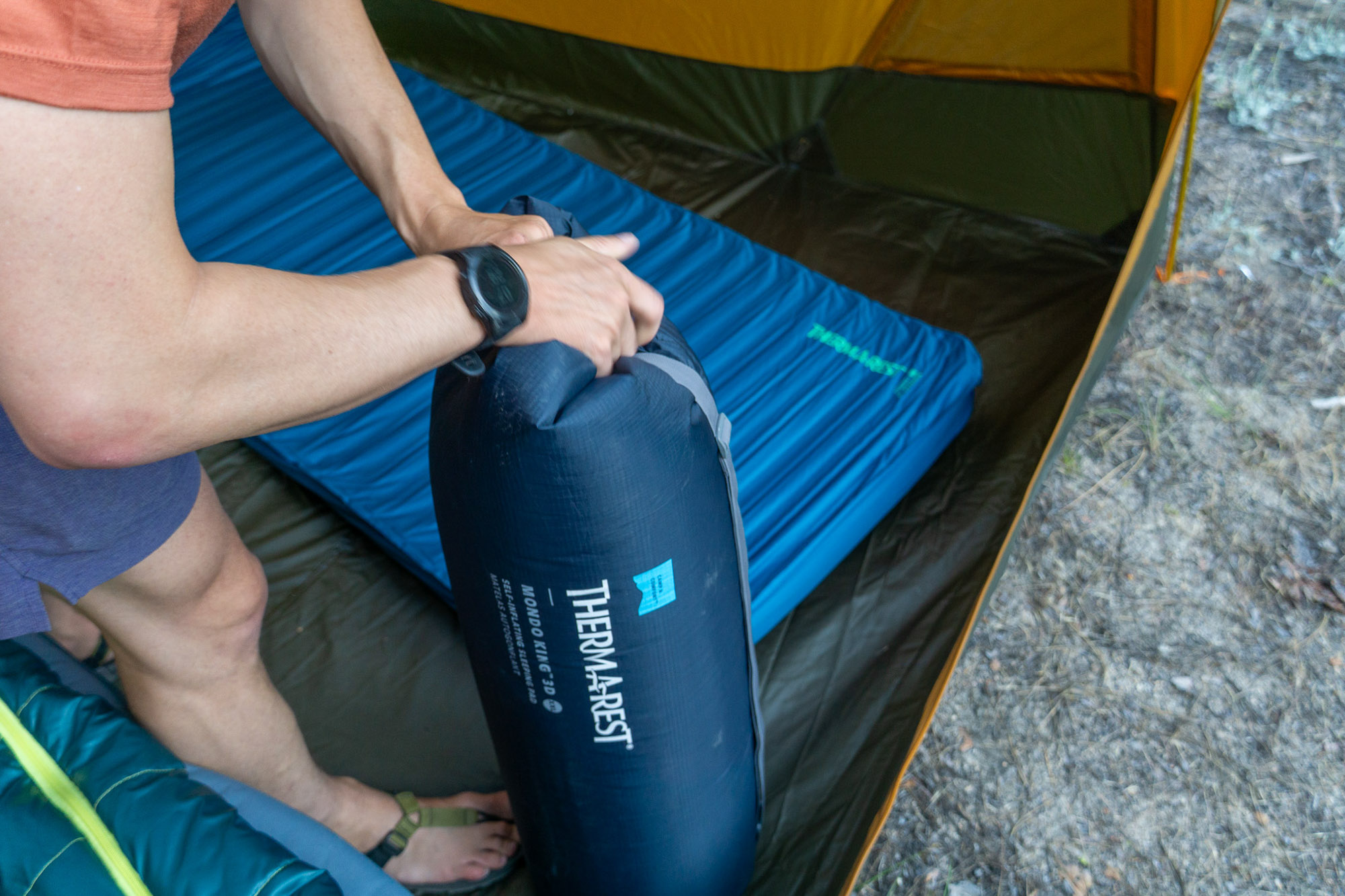 Detailed view of the author using the included pump sack to add air to the mattress.
