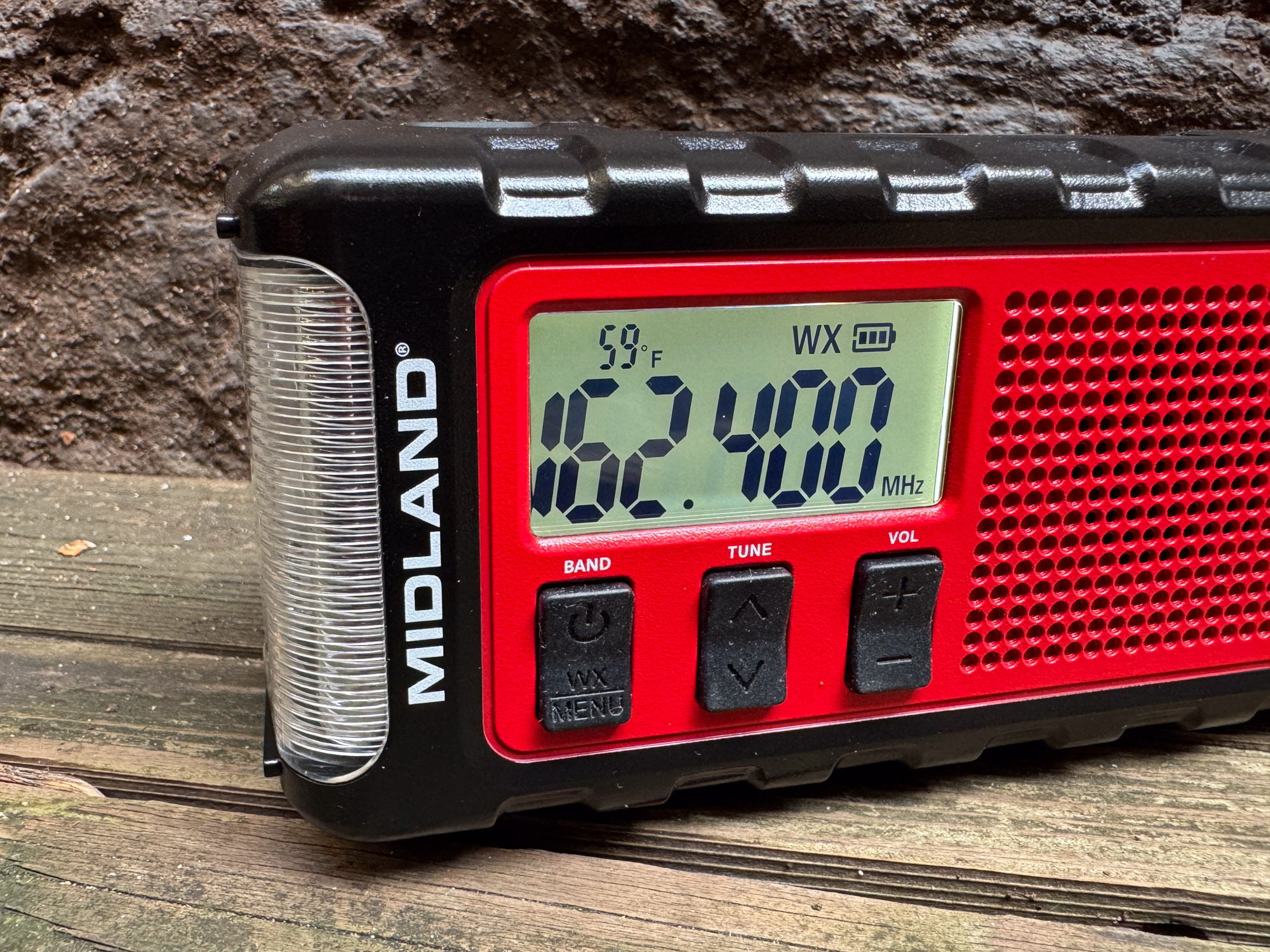 The ER310PRO radio display showing a NOAA weather frequency.