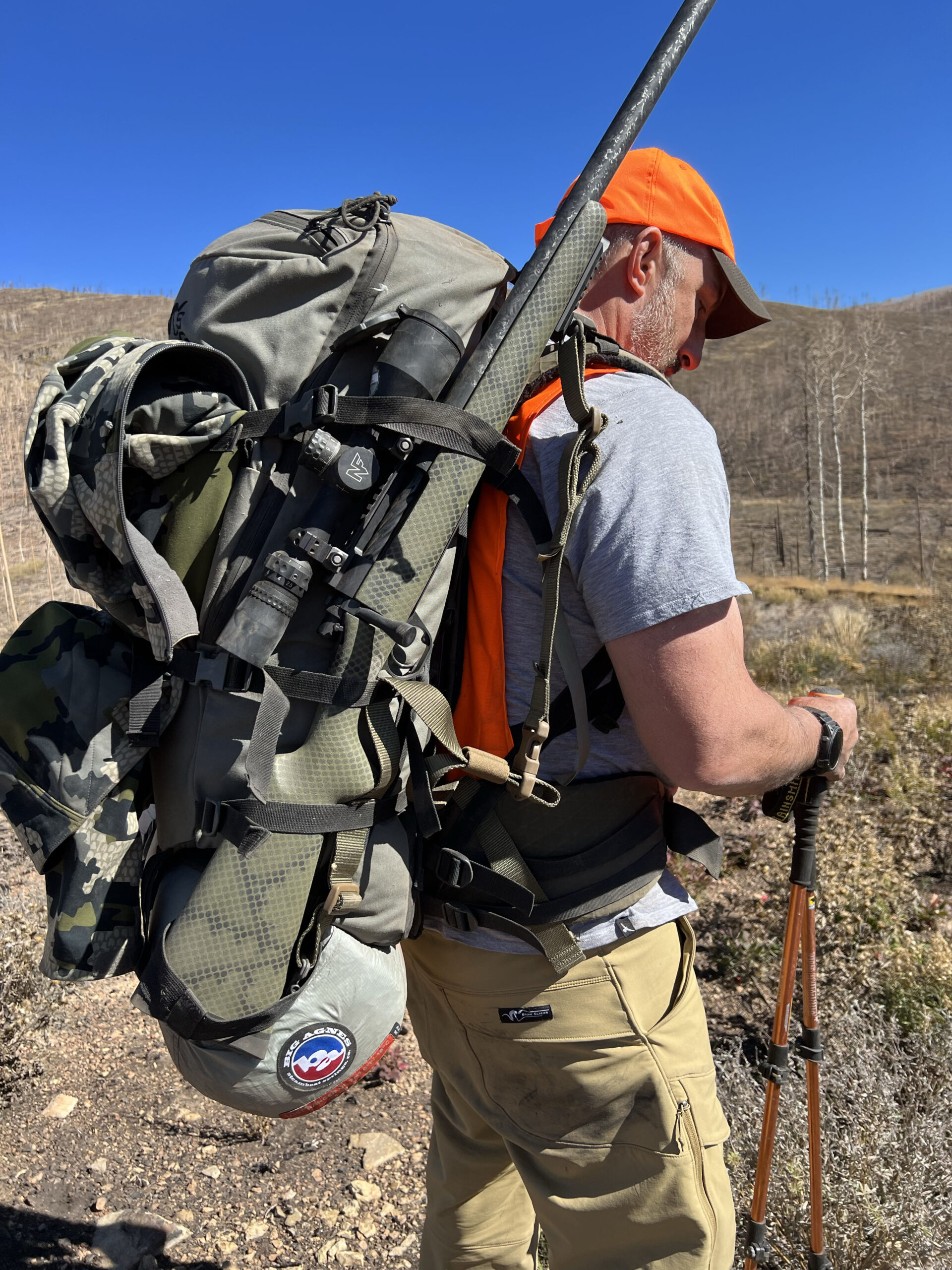A tester carrying a heavily loaded Stone Glacier backpack in the mountains.