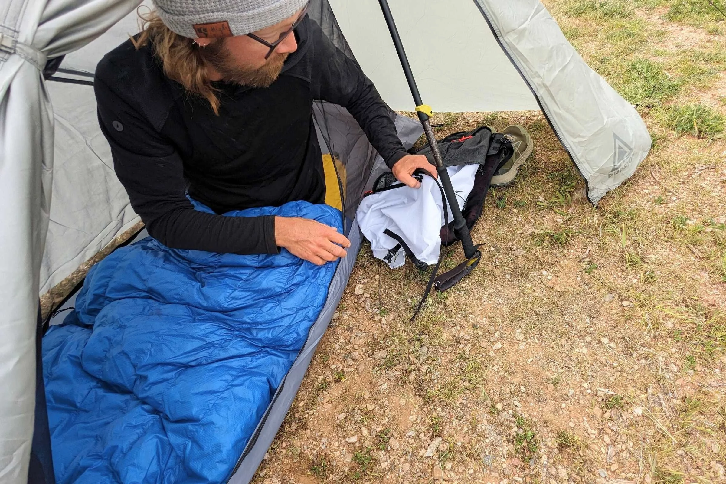 A Durston Gear X-Mid 1 tent pitched in an open grassy field showing its distinctive double-peak design.