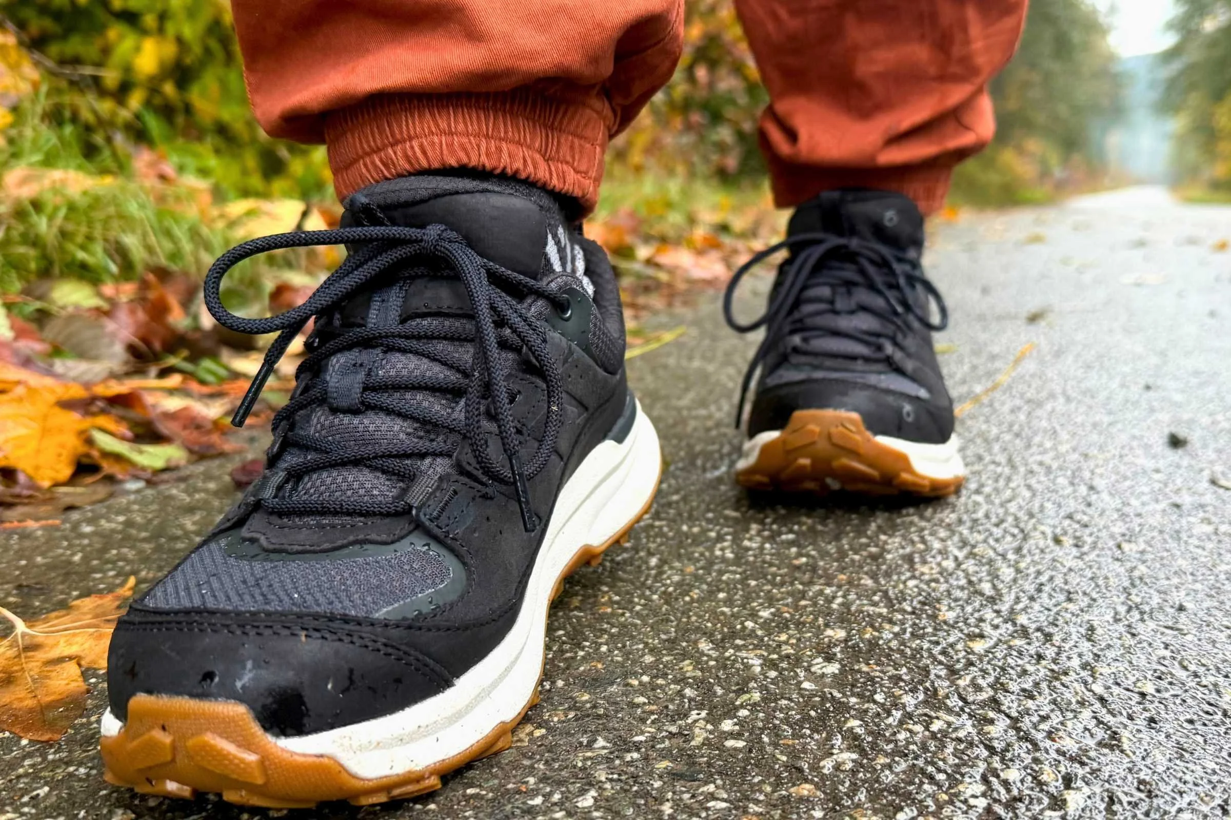 A person wearing Oboz Hyalite Low shoes walking on rocky, uneven ground.