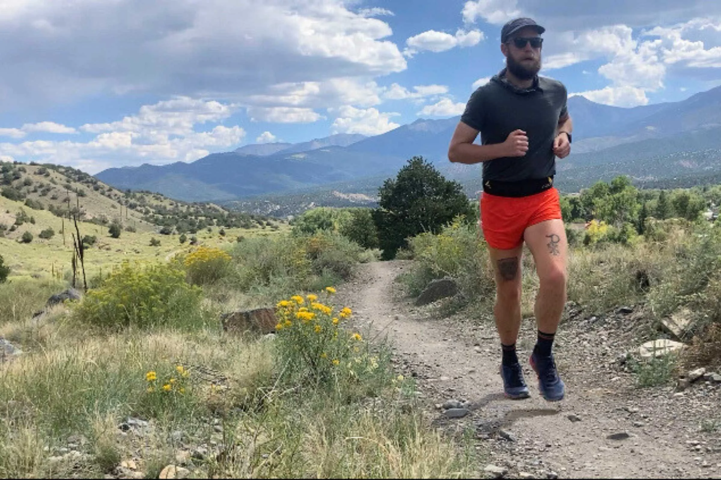 A runner wearing black Tifosi Swank sunglasses during a run in bright sunlight.