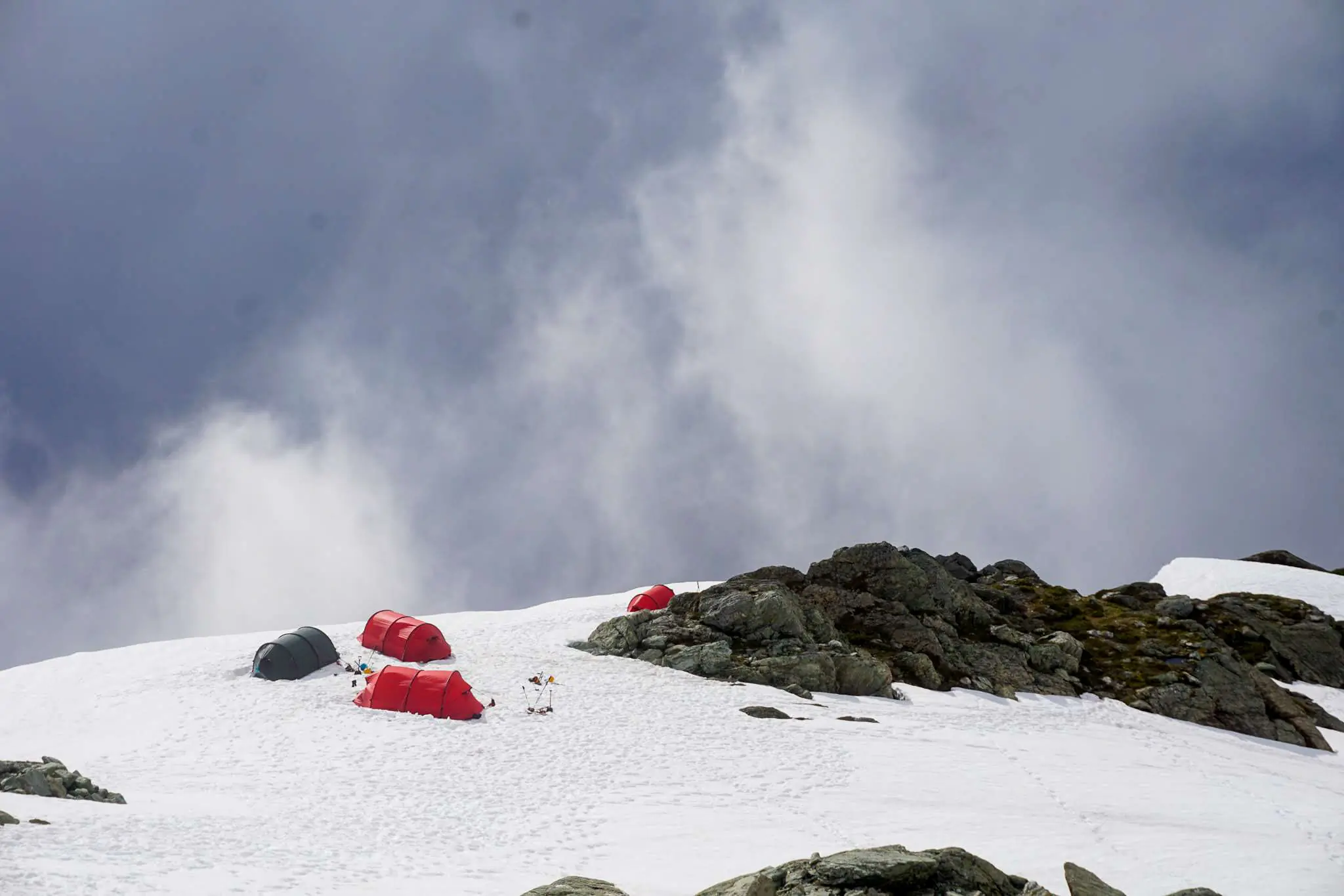 Red Hilleberg tunnel-style tents pitched on the slopes of Mt. Shuksan.