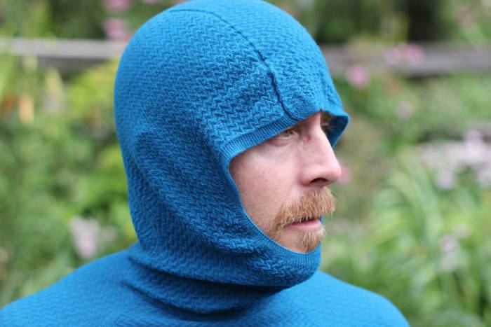 Macro close-up showing the intricate knit texture of a Patagonia merino air base layer.