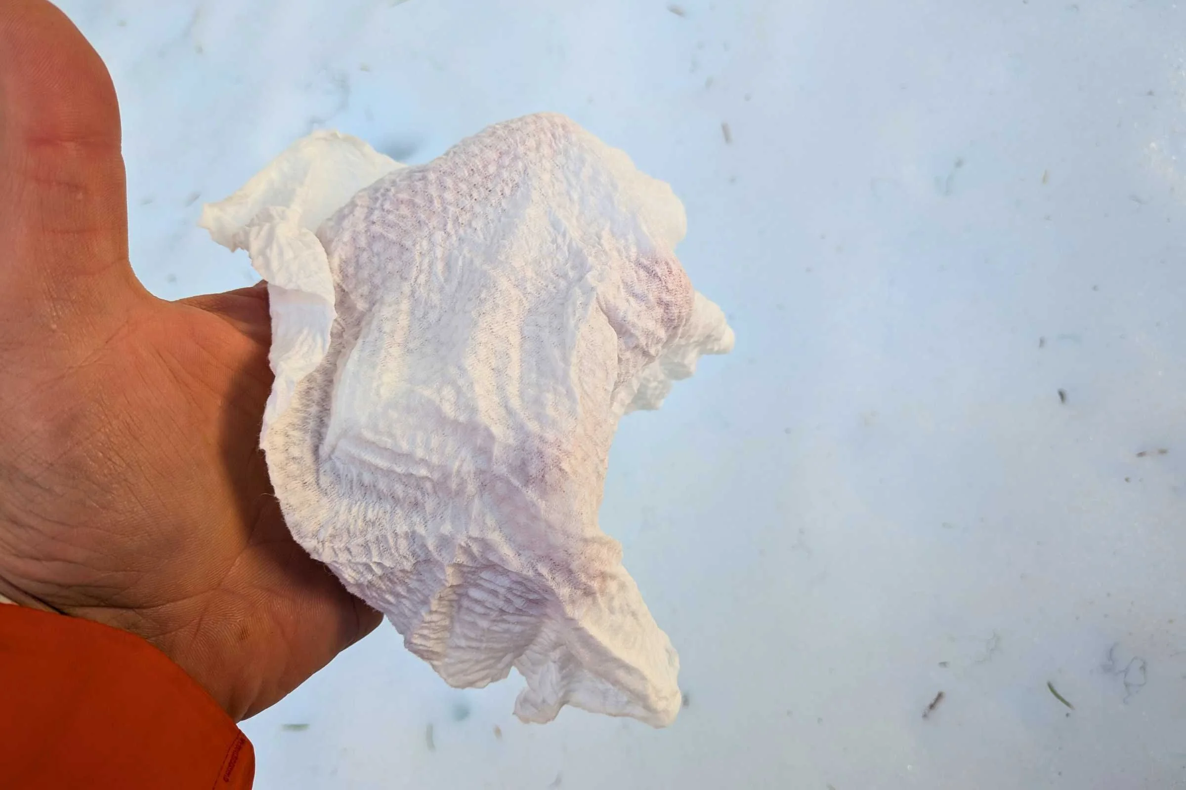 Compressed tabs expanding into wet wipes with the addition of water.