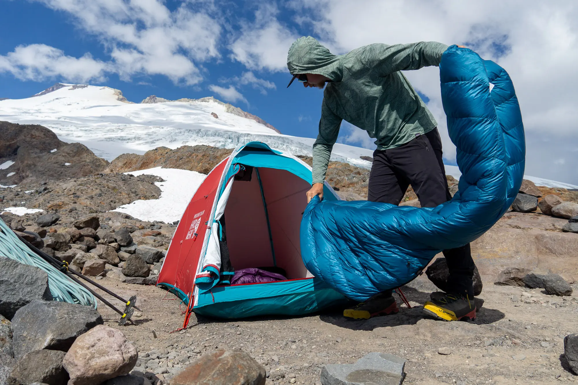 Gear testers evaluating the stability of several 4-season tents in a snowy alpine environment.