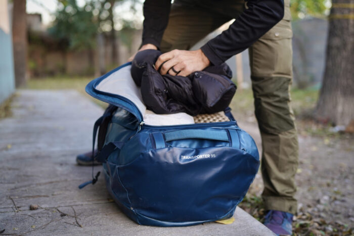 Close-up view of a duffel bag with a large U-shaped main compartment opening.
