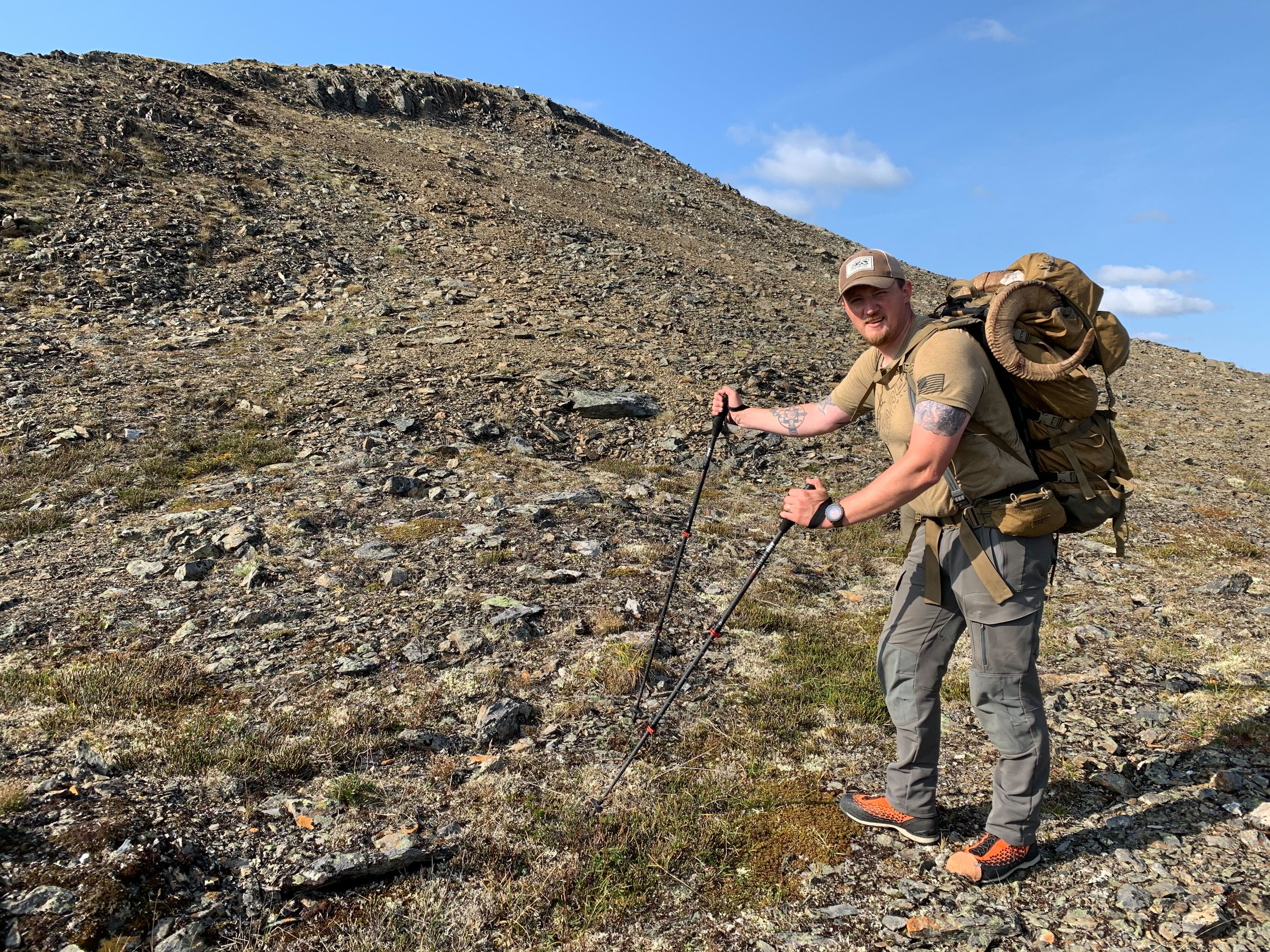 The Kifaru Dall backpack carrying a heavy load in rugged terrain.