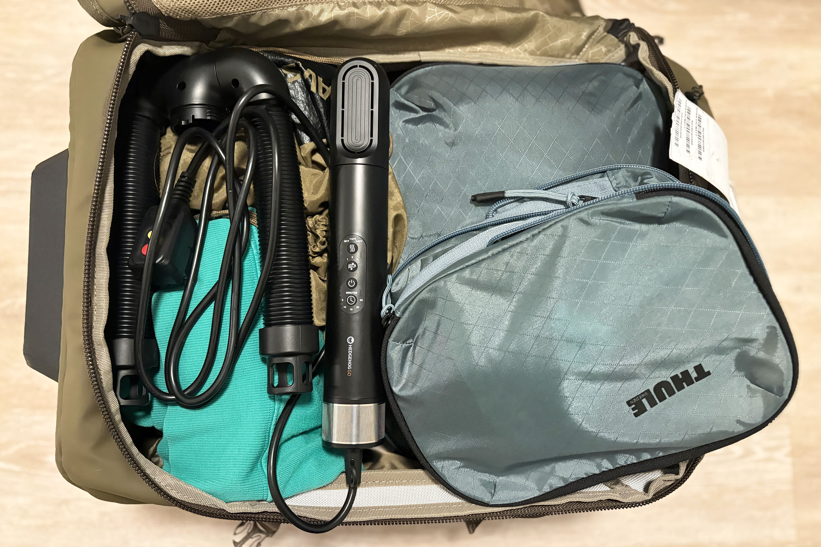 The Hedgehog GO unit and attachments neatly packed inside a carry-on suitcase.