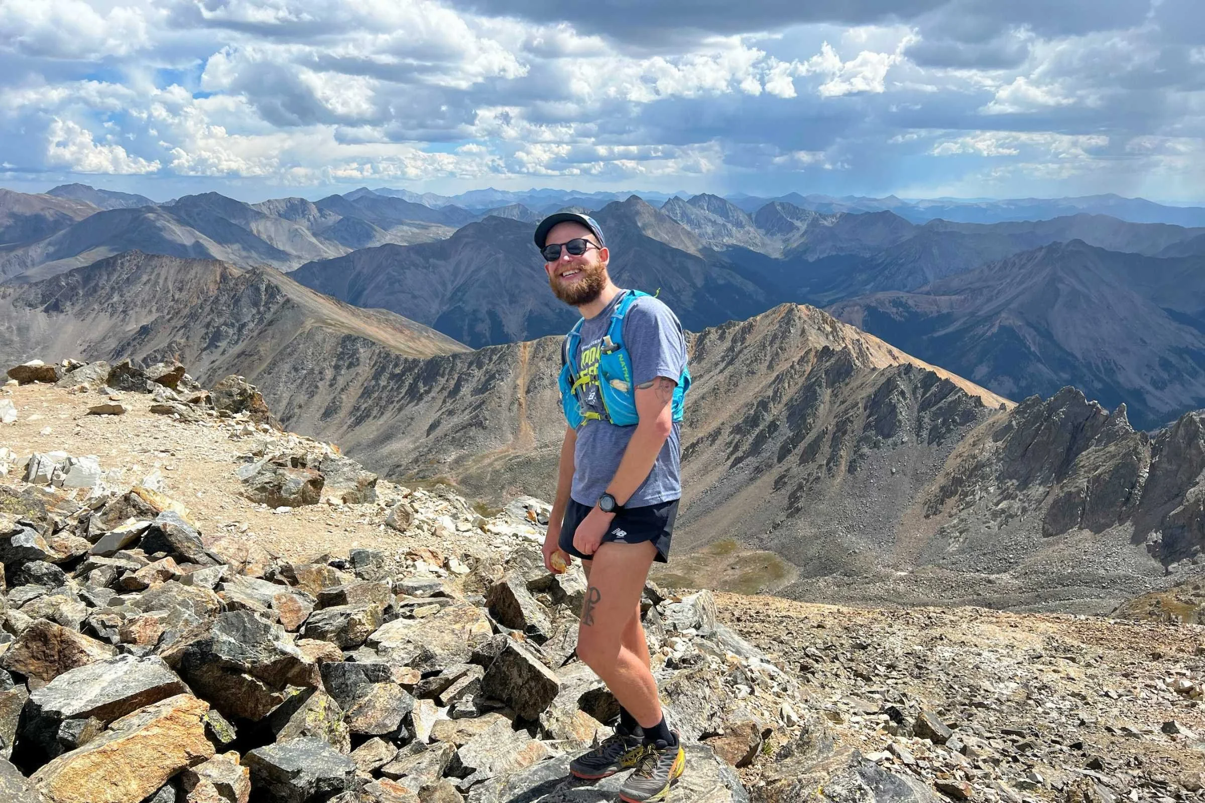 A runner at 14,000 feet wearing Roka Oslo sunglasses after a long mountain traverse.