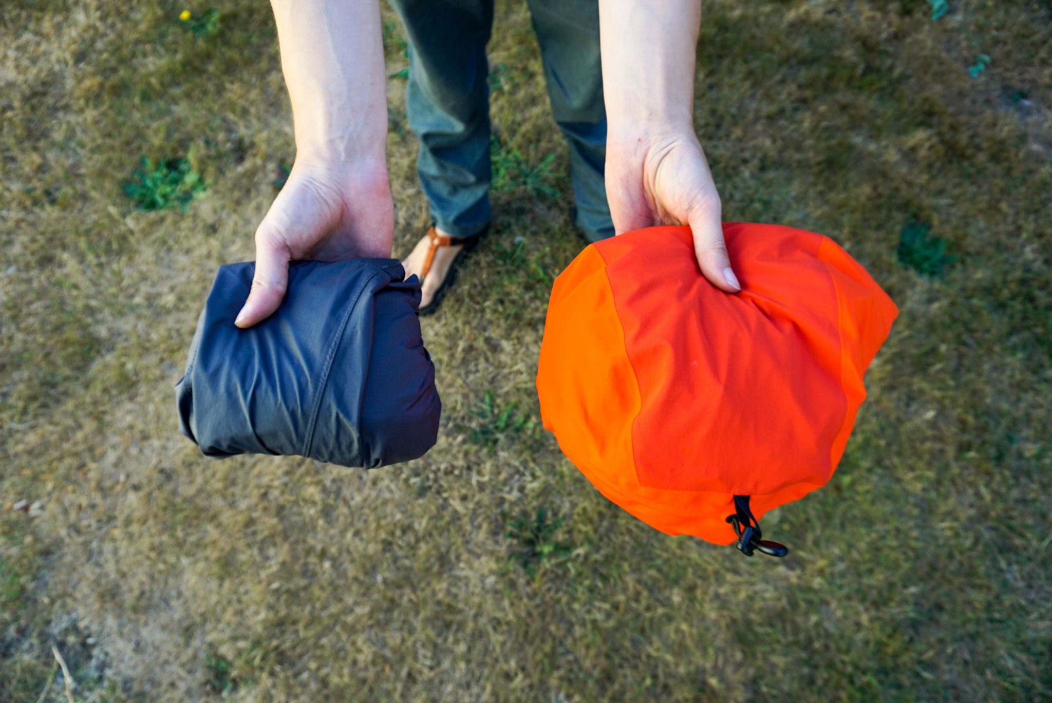 A comparison of several rain jackets folded to show their packed volume.