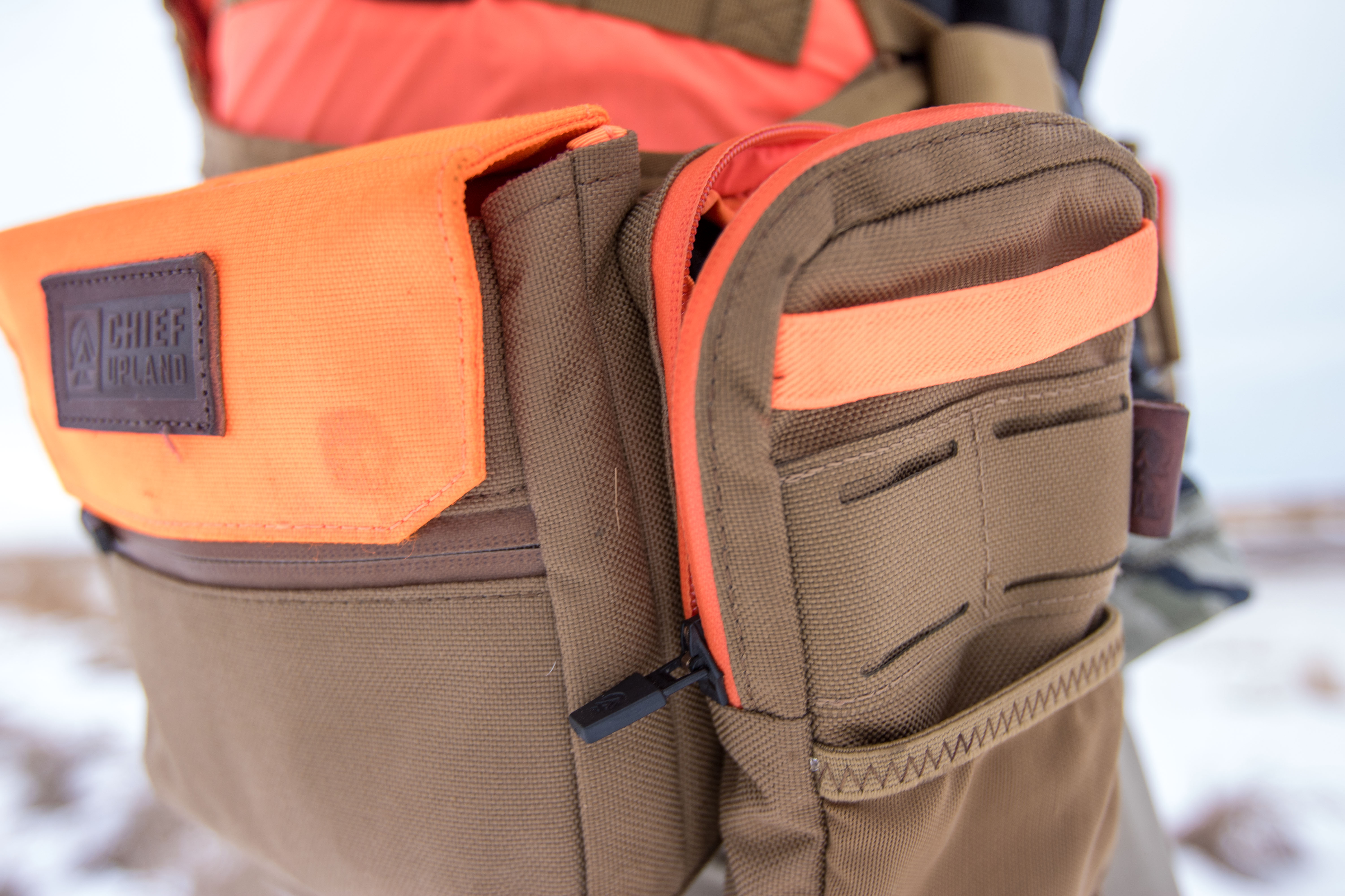 Ammo and electronics pouches securely attached to the side of the vest.