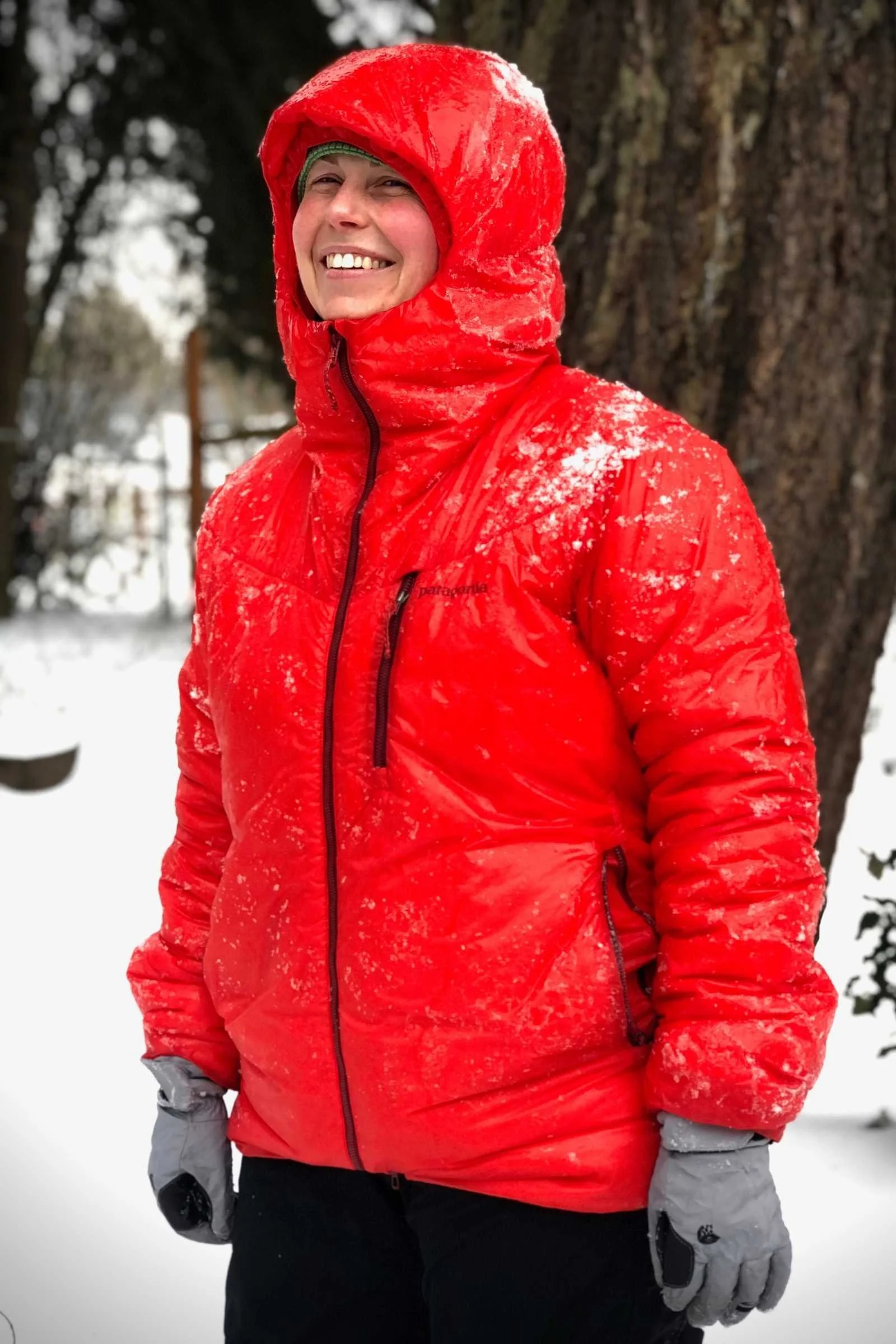 A woman wearing the heavy-duty Patagonia DAS Parka in a heavy snowstorm