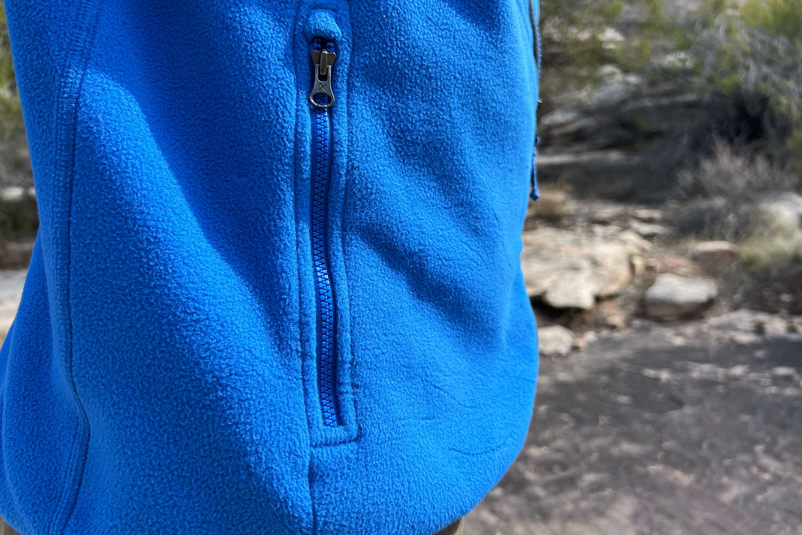A person showcasing the relaxed and boxy fit of the REI Trailmade Fleece Jacket