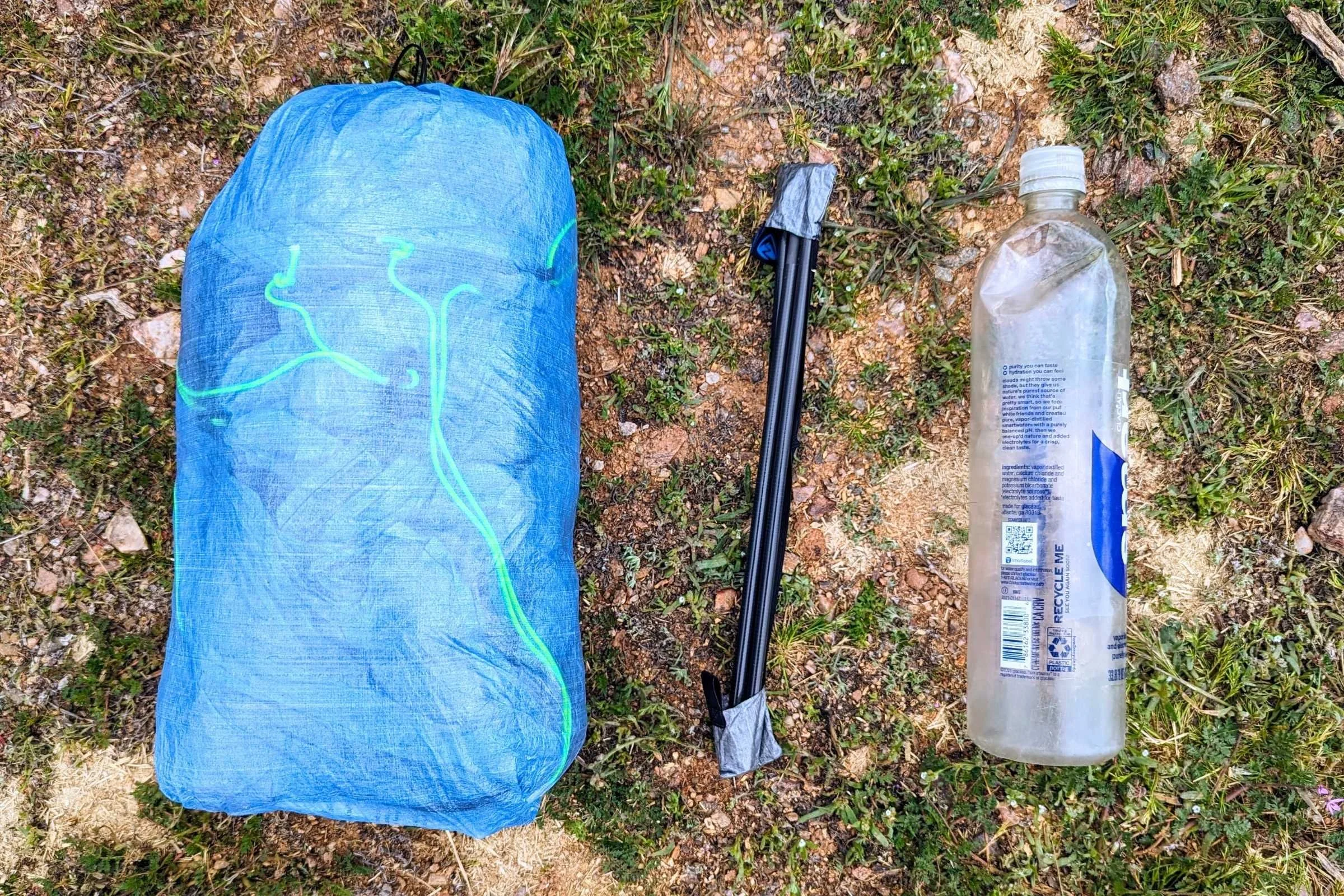 The Zpacks Pivot Solo tent pitched on a forest floor, showcasing its elongated footprint.