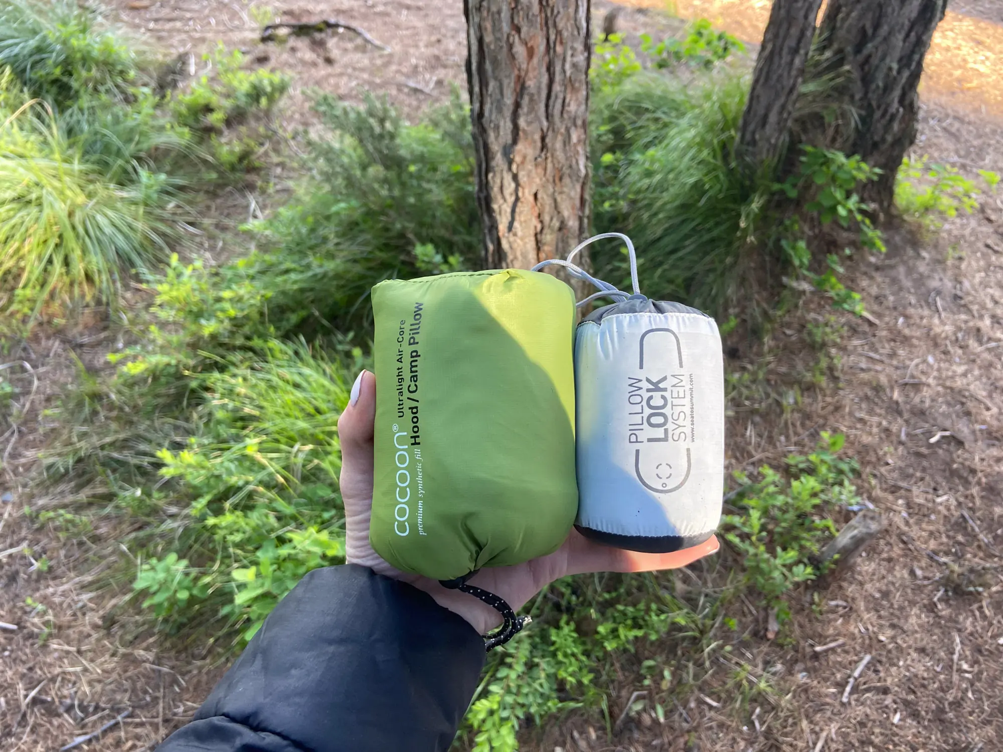 A digital scale showing the weight of a backpacking pillow in grams.