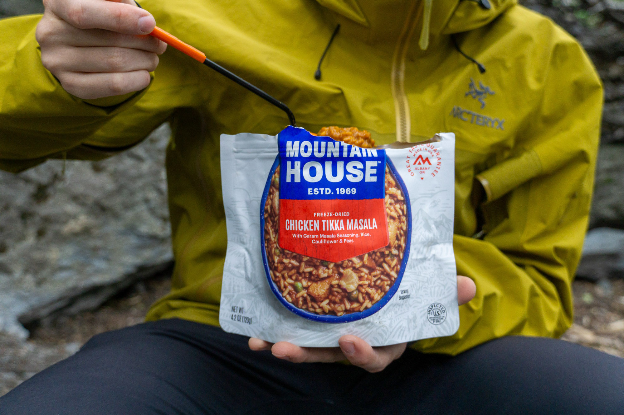 Group of testers evaluating several bowls of freeze-dried food on a table.