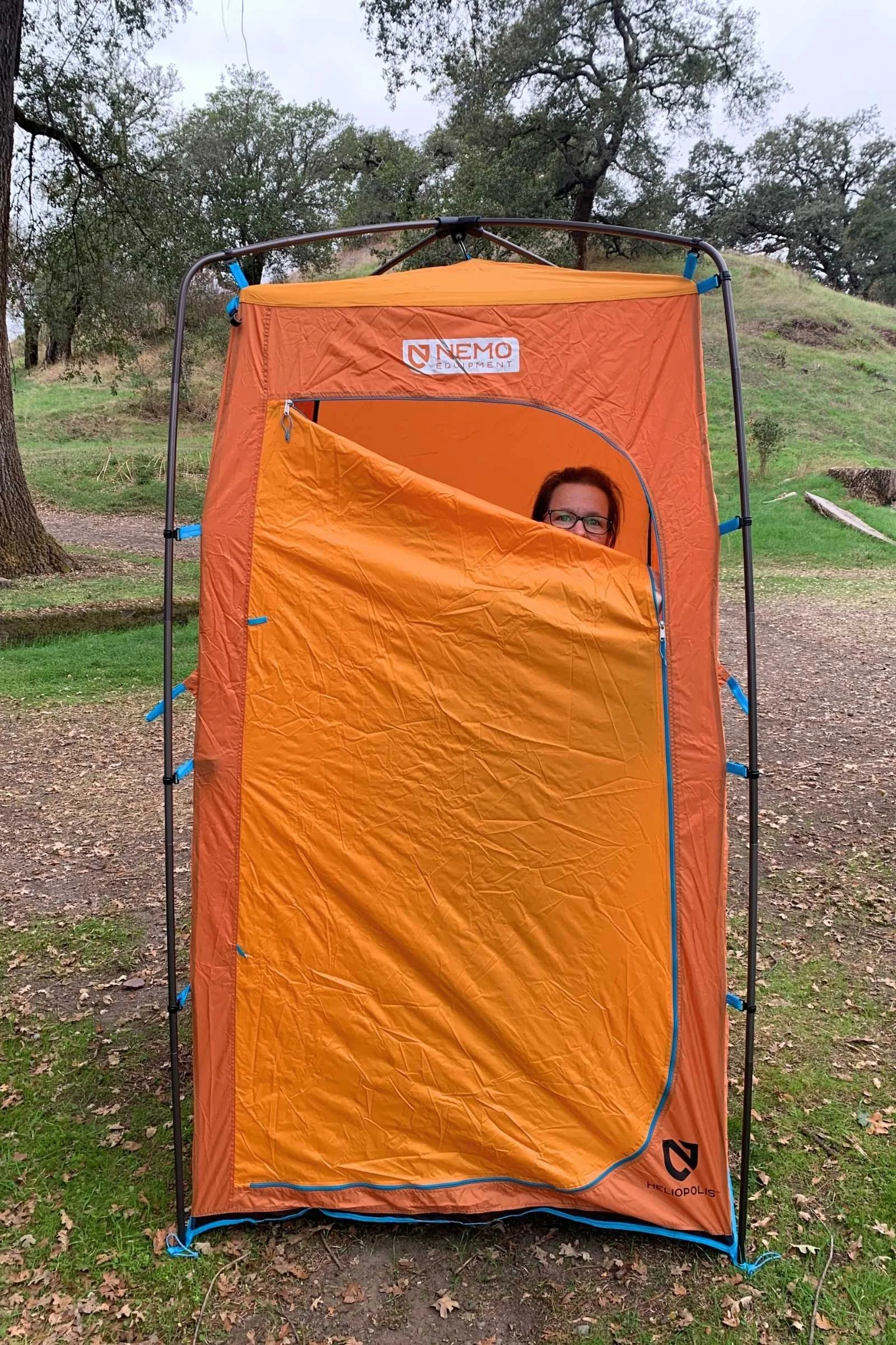A Nemo Heliopolis privacy tent set up at a grassy campsite.