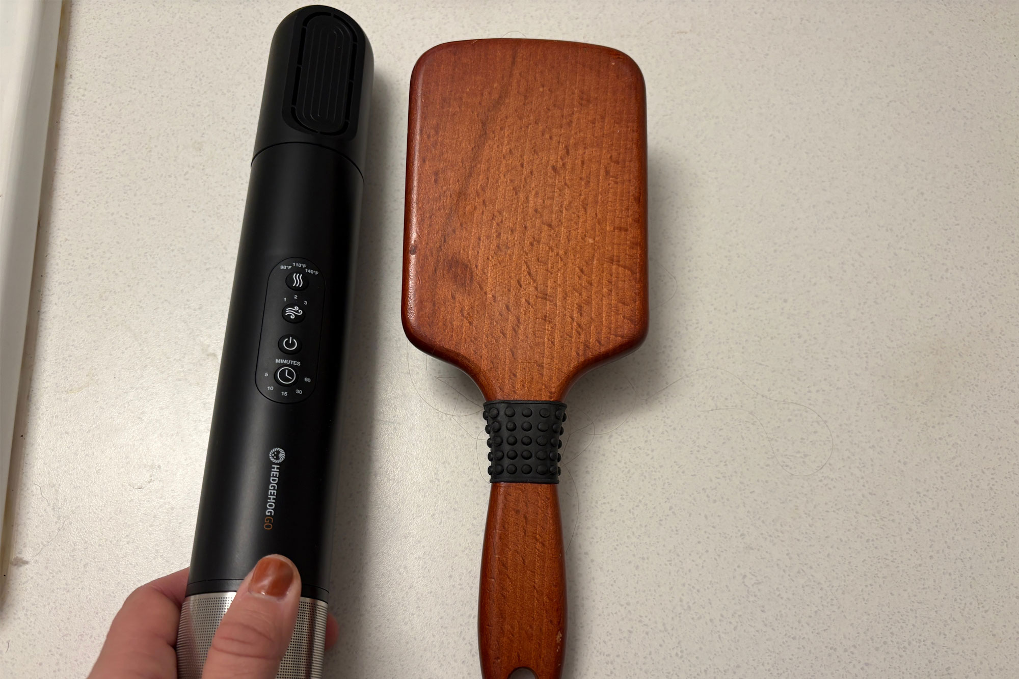 The Hedgehog GO base handle shown next to its interchangeable drying attachments.