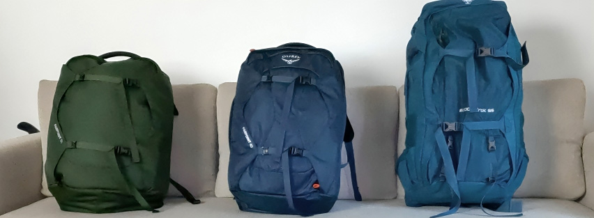 A lineup of various Osprey Farpoint backpacks showing different sizes and colors.