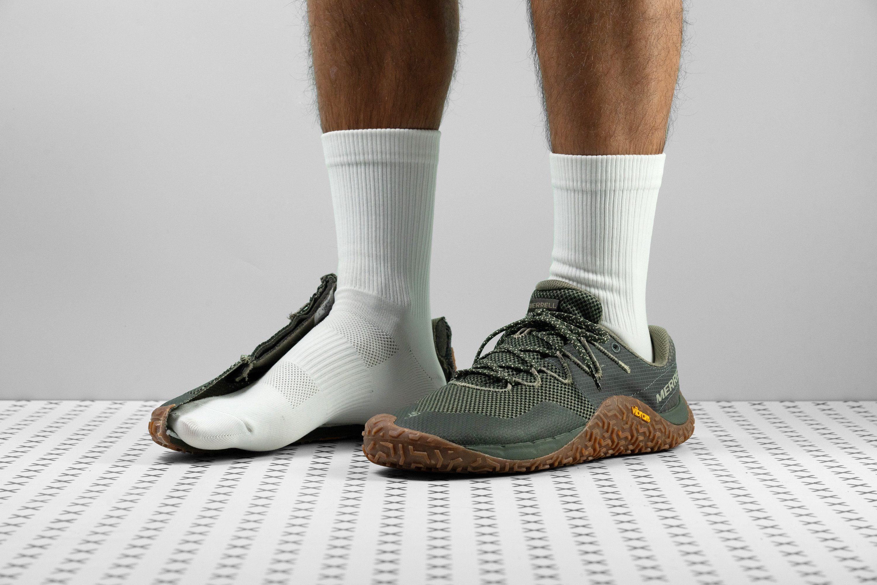 A Merrell Trail Glove 7 barefoot shoe showing its rugged Vibram outsole.