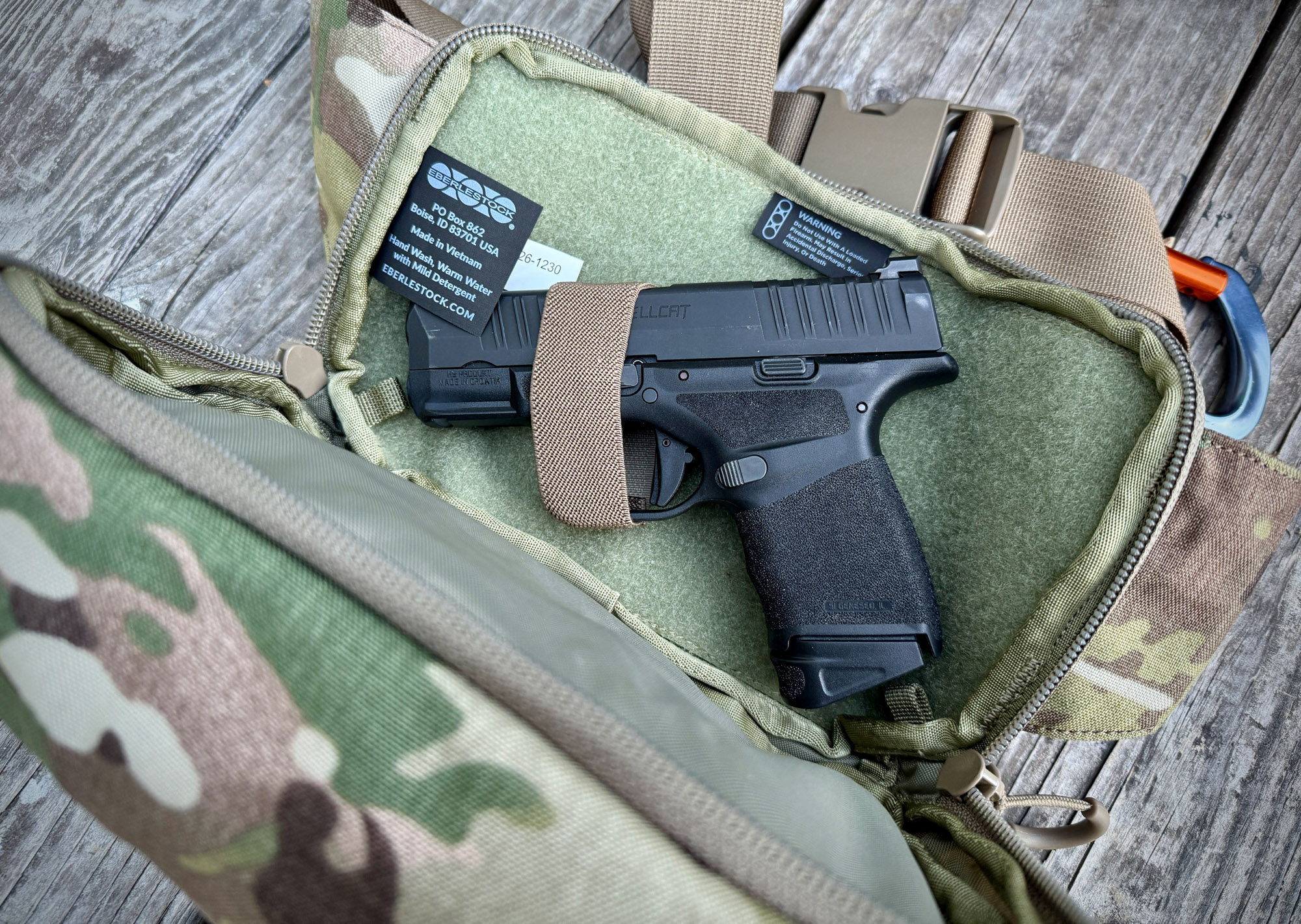 A dedicated internal compartment in a backpack designed for secure weapon storage