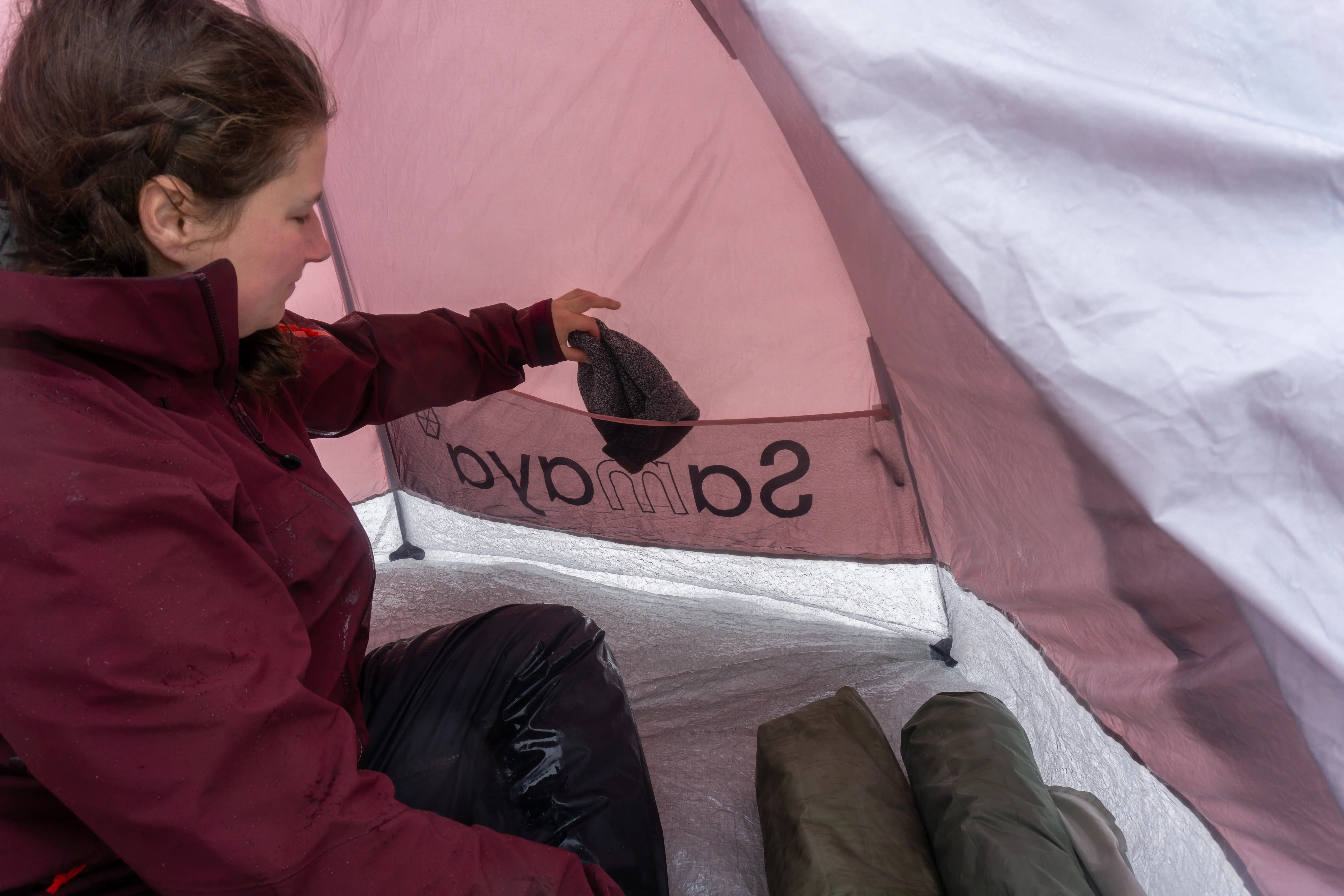 Interior view of a 4-season tent showing gear lofts and mesh storage pockets filled with winter accessories.