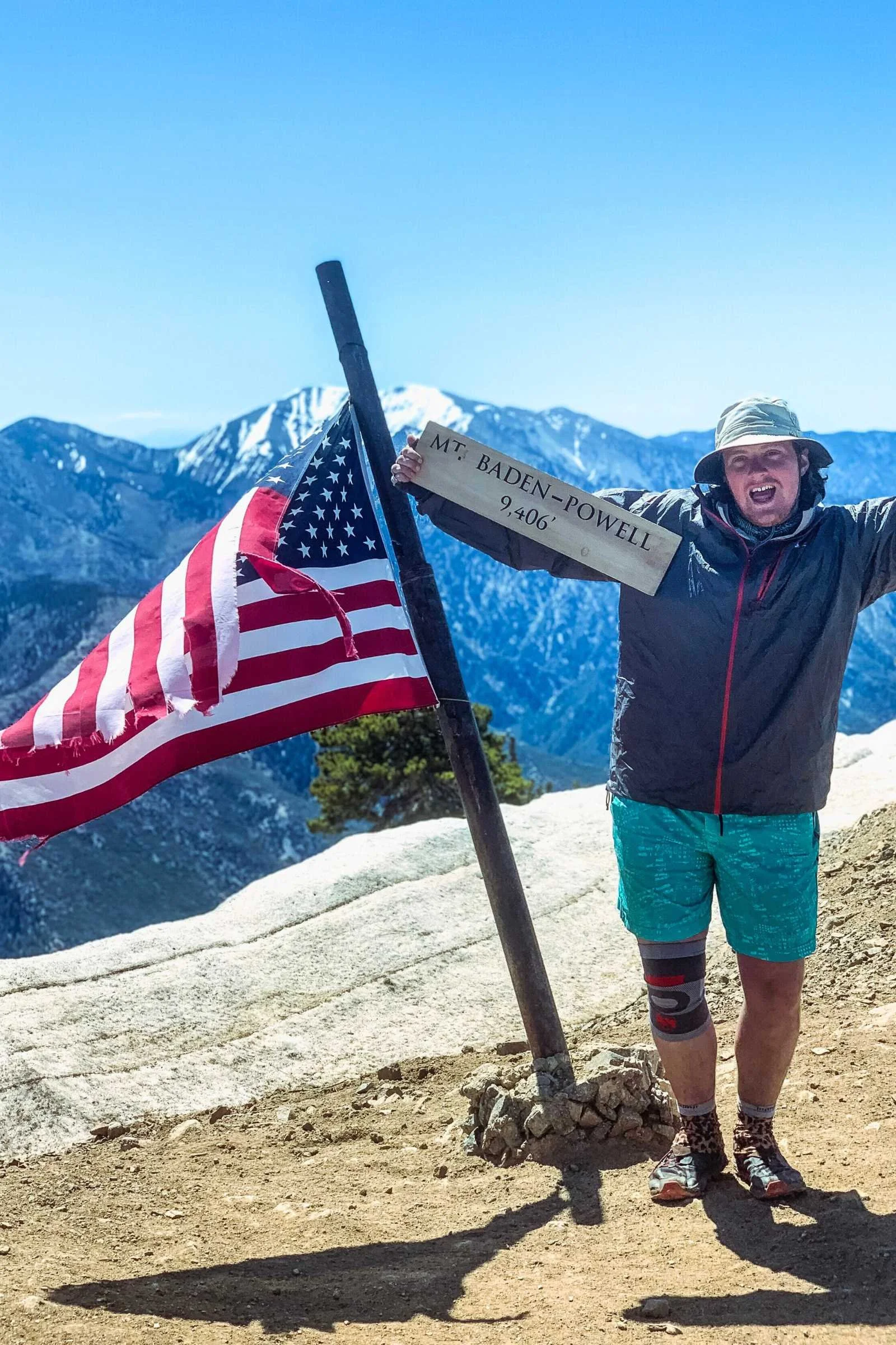 A hiker standing at the summit of Mt. Baden Powell wearing Lululemon shorts.