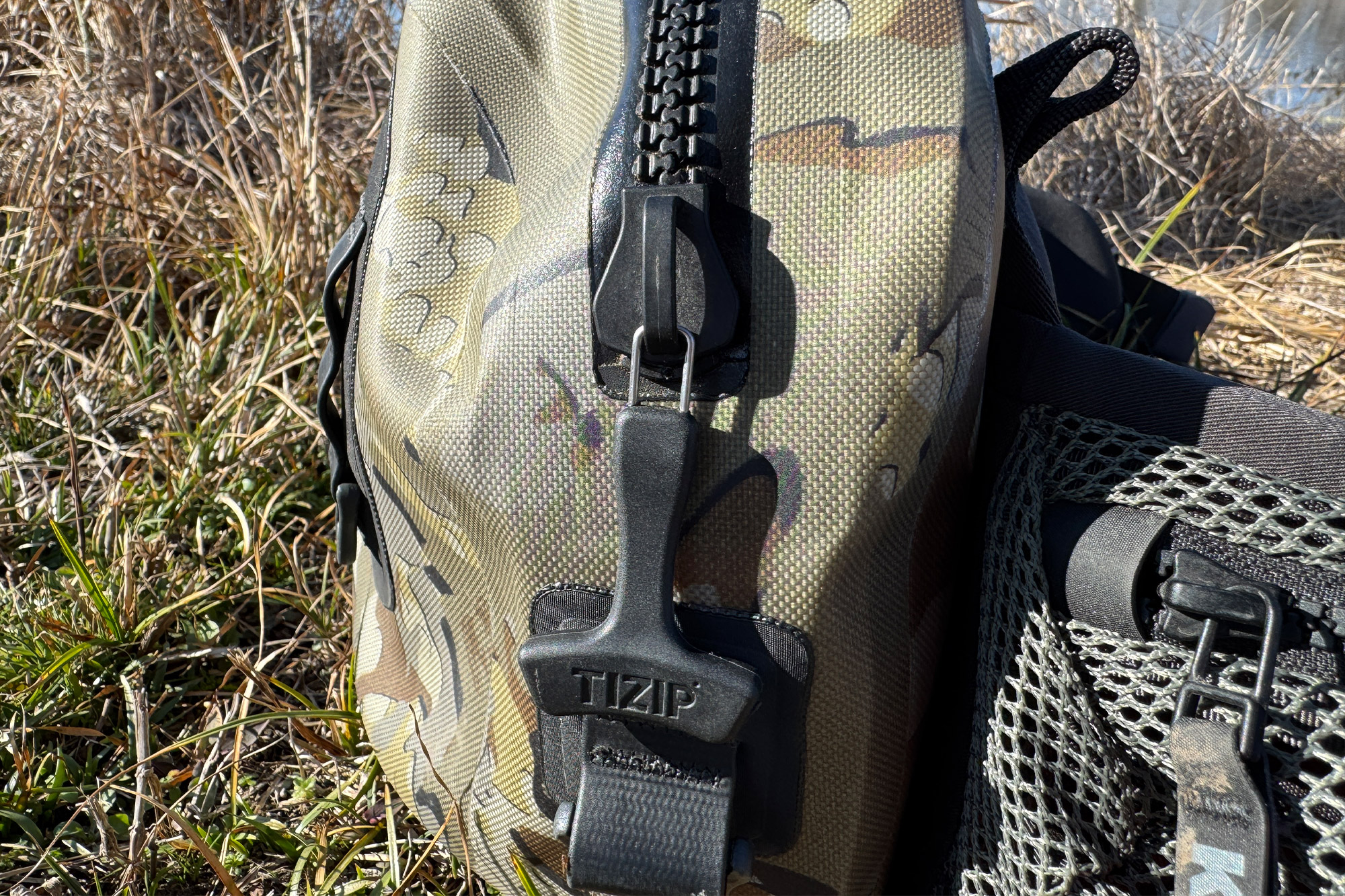 Detailed close-up of the TIZIP MasterSeal waterproof zipper and pull cord on the KUIU waistpack.