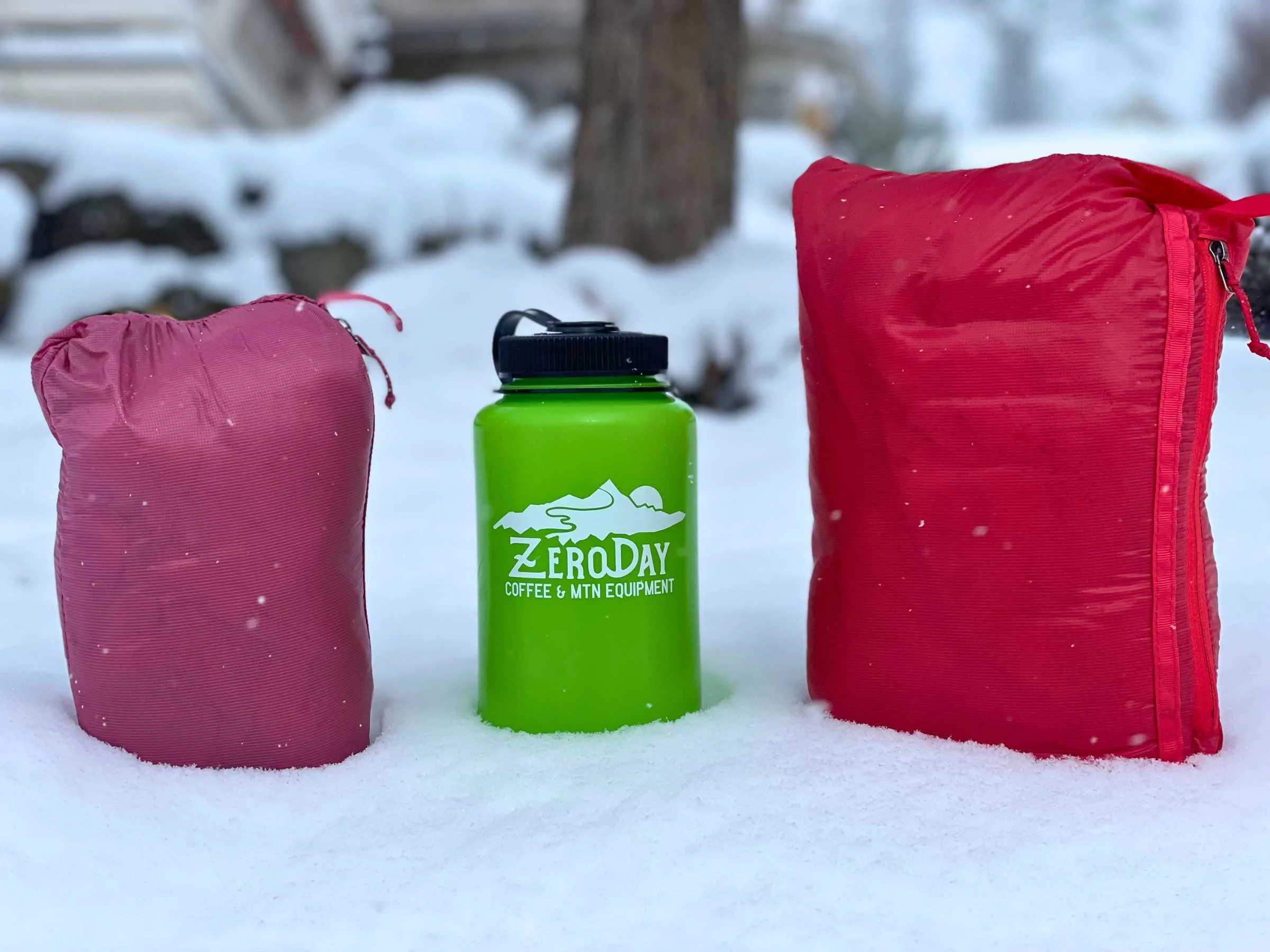 A compressed Patagonia Micro Puff jacket next to a standard water bottle