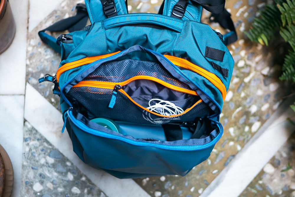 Interior view of a Cotopaxi backpack showing multiple mesh compartments and organization pockets.