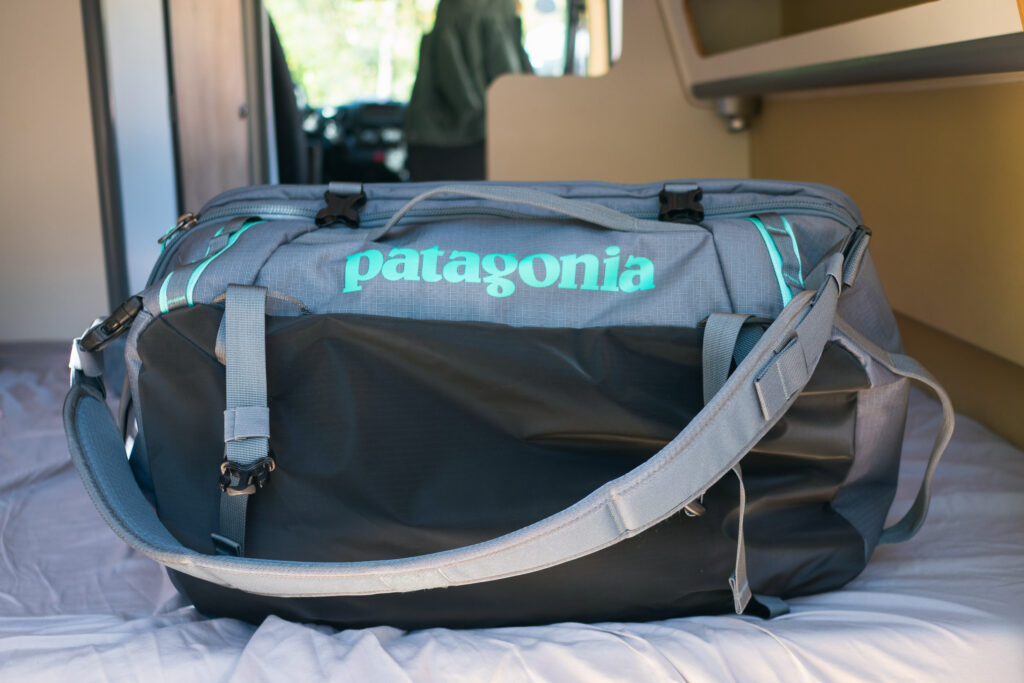A Patagonia Black Hole MLC bag being carried as a backpack for travel.