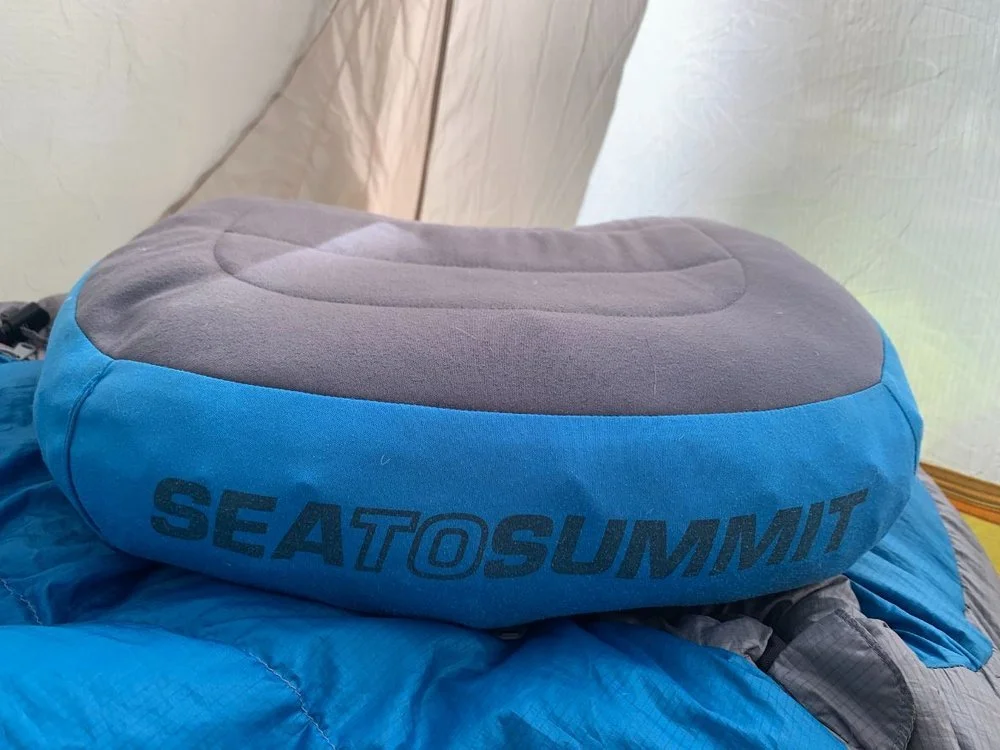 A blue Sea to Summit Aeros Premium inflatable pillow showing its soft top fabric and contoured shape.
