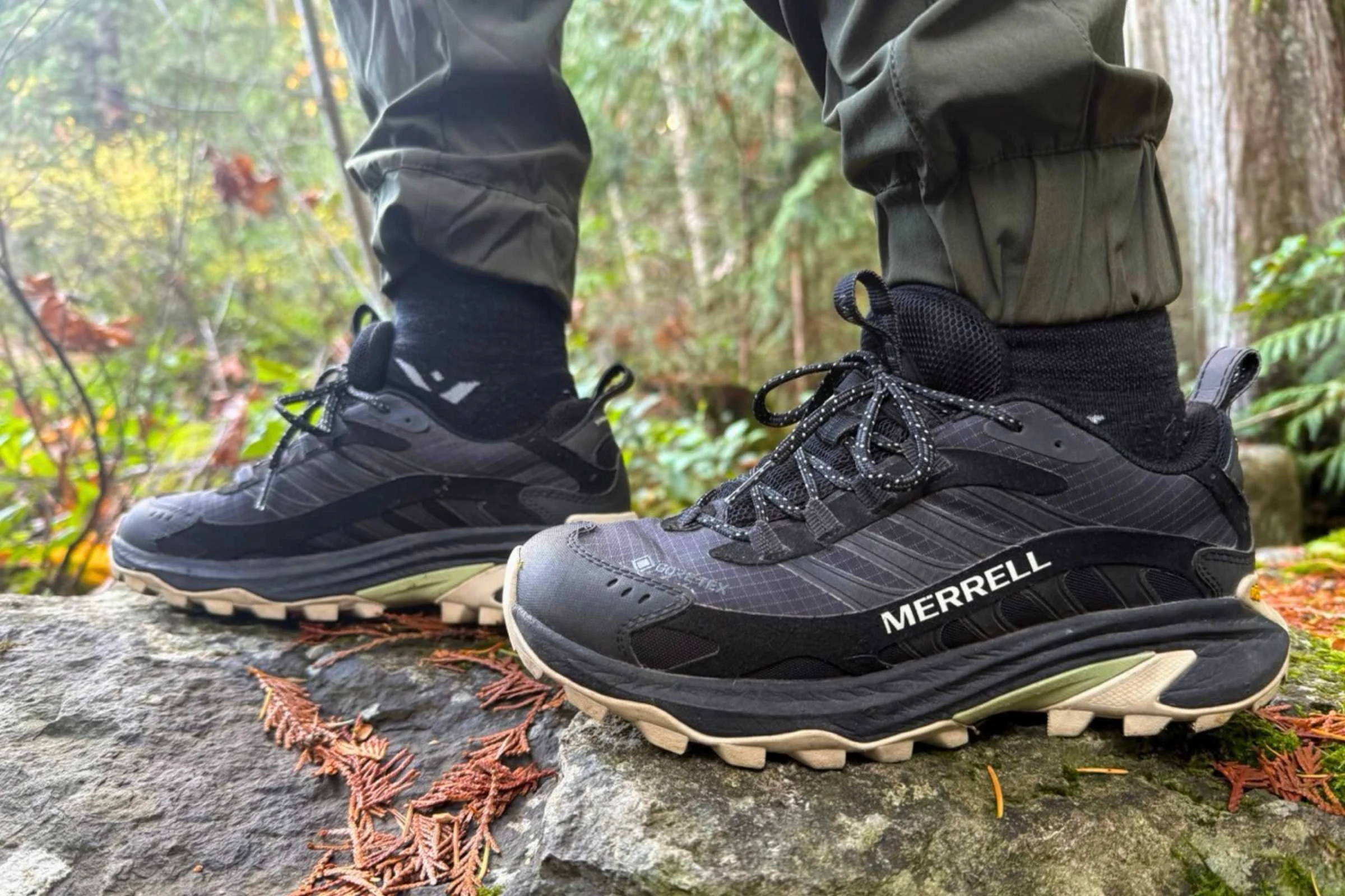 A pair of Merrell Moab Speed 2 GTX hiking shoes on a rocky surface.