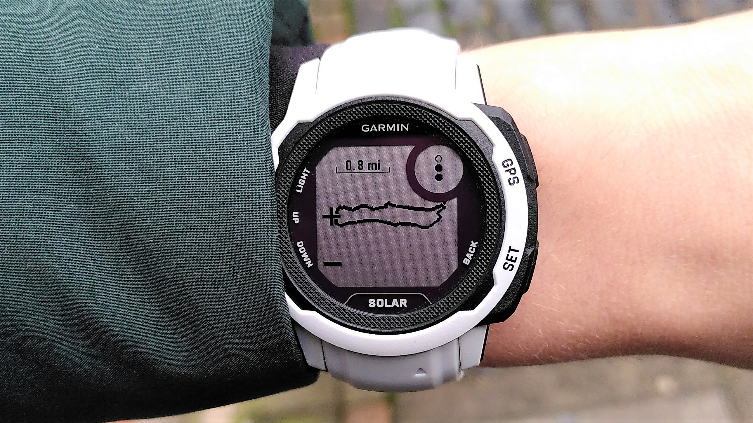 The Garmin Instinct 2 display showing a breadcrumb navigation path and route mapping.
