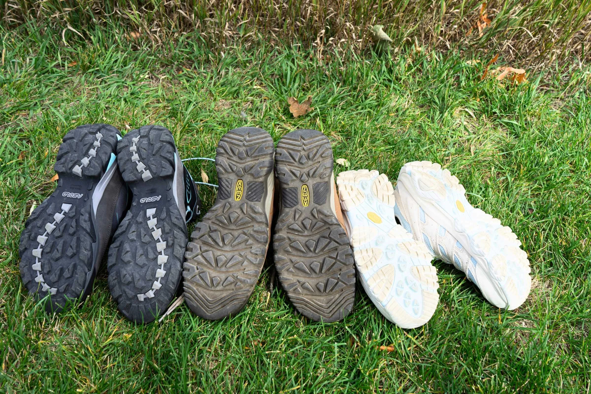 A comparison showing the different lug patterns and rubber outsoles of several hiking boots.
