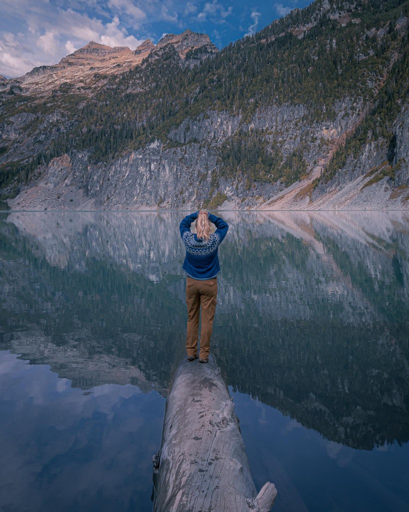 A hiker overlooks Blanca Lake in the North Cascades while wearing versatile hiking gear.