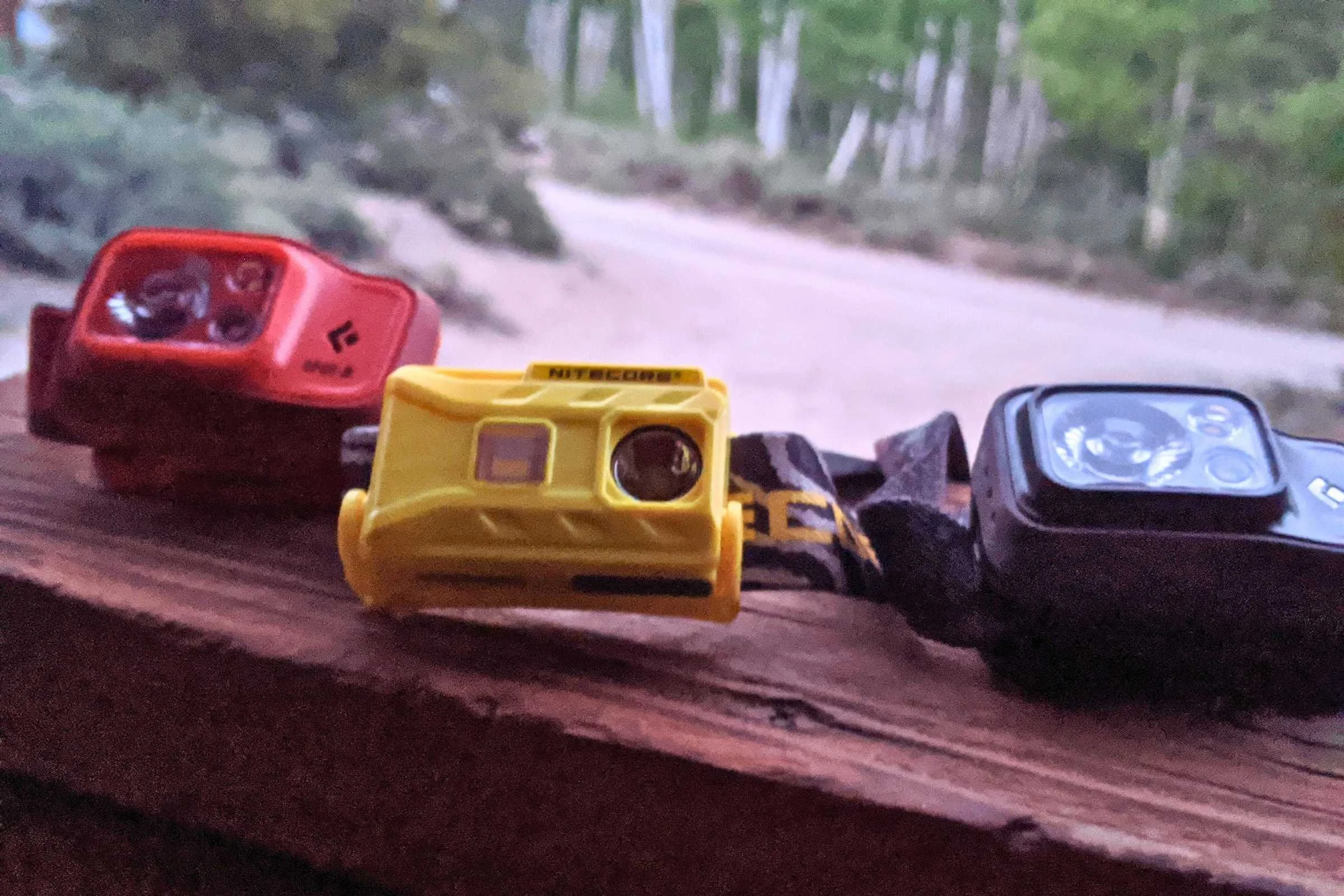 The Black Diamond Spot 400 placed next to several other competing headlamp models for size comparison.