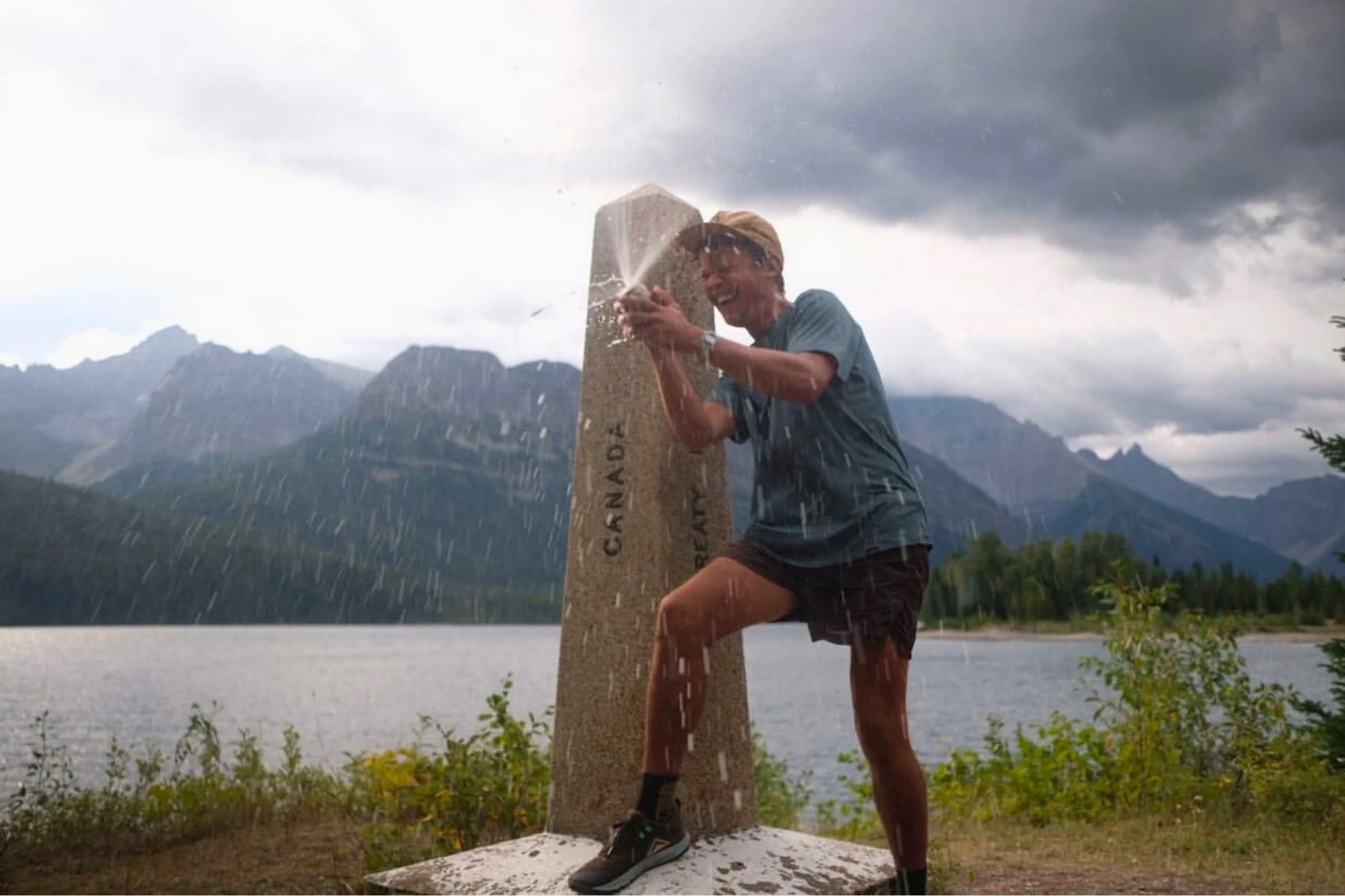 Hiker Andrew Glenn wearing Patagonia Strider Pro shorts on a scenic mountain ridge.