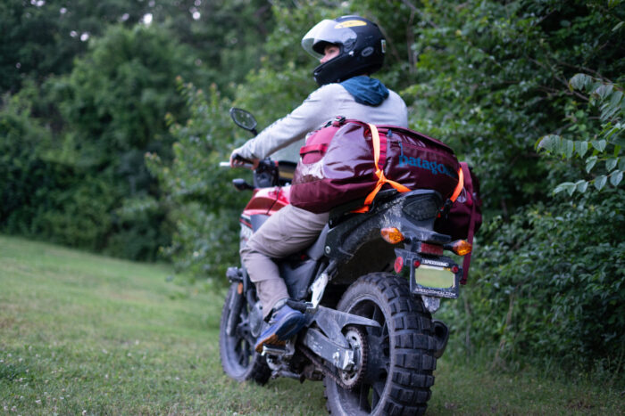 Duffel bags securely lashed to a vehicle for transport.