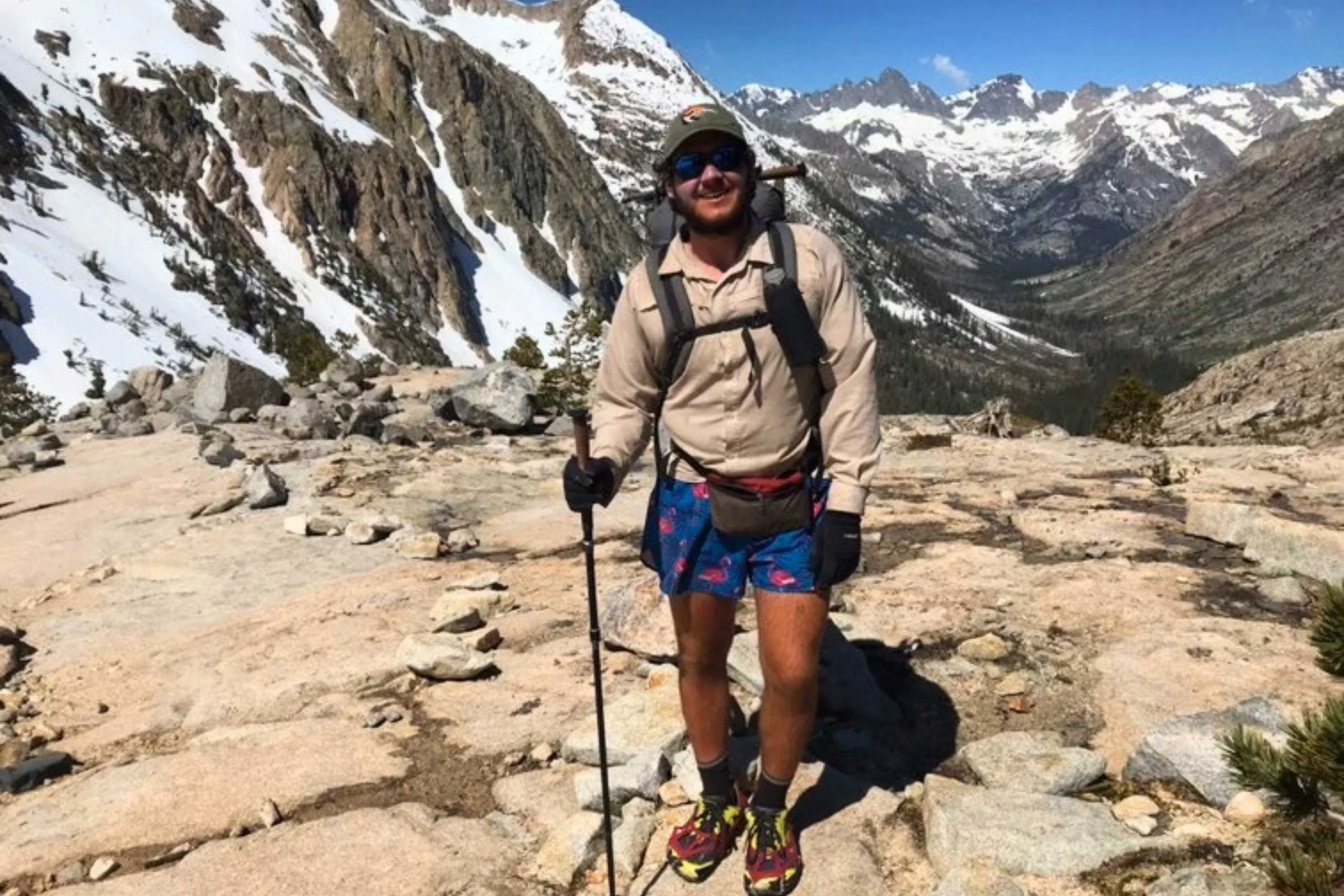 Oakley Aguiar wearing brightly patterned short shorts in a mountain setting.
